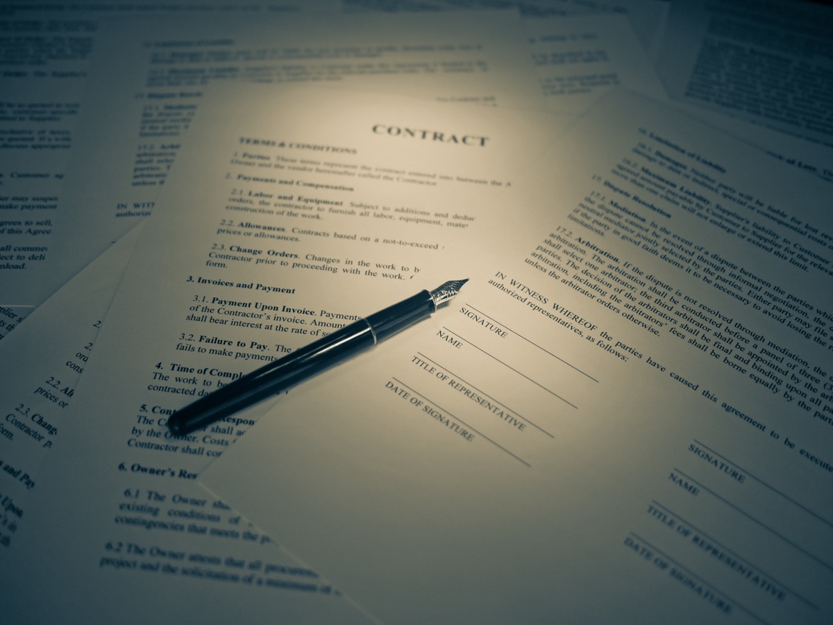 Pen resting on a signed contract